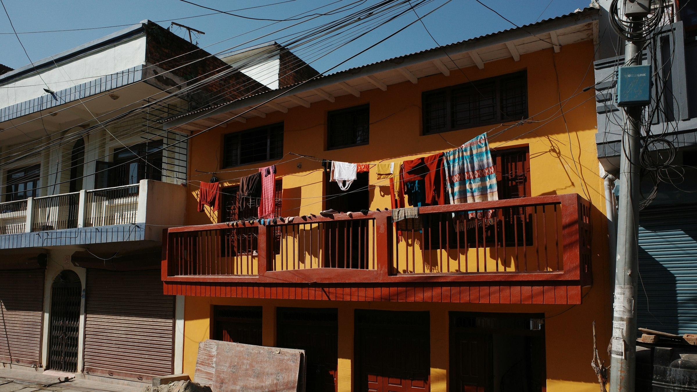 Colourful laundry drying on a residential balcony